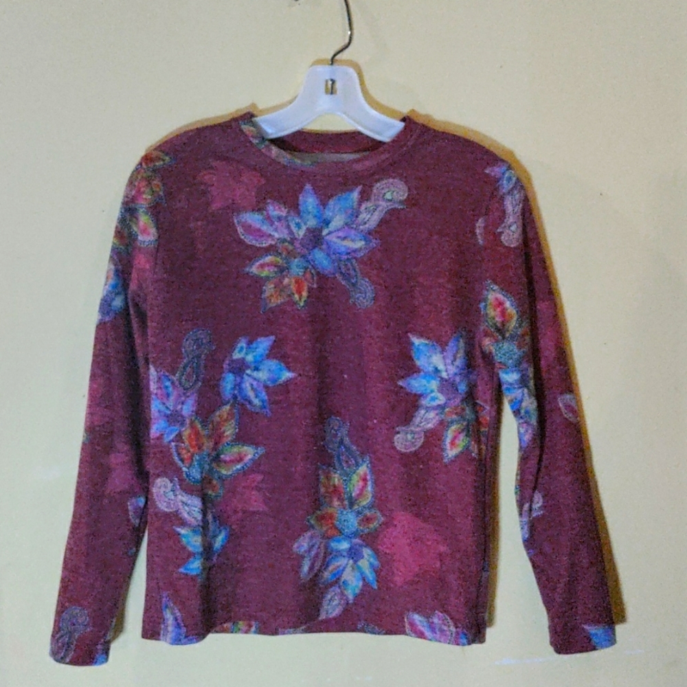 Maroon light sweater with colorful flowers.